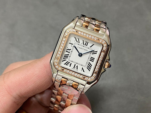 Cartier square dial wristwatch with Roman numerals, diamond bezel, two-tone metal bracelet