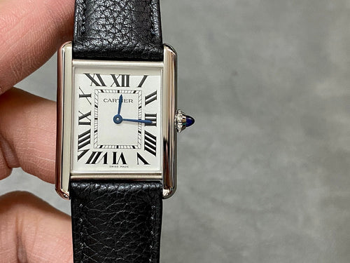 Rectangular watch with black leather strap and white dial, Roman numerals, crown on right.