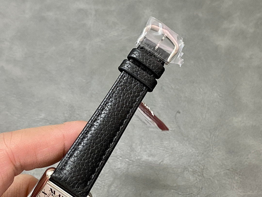 Black leather watch strap with buckle, clear protective cover over clasp