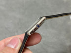 Cartier watch side profile with blue crown detail and polished metal case