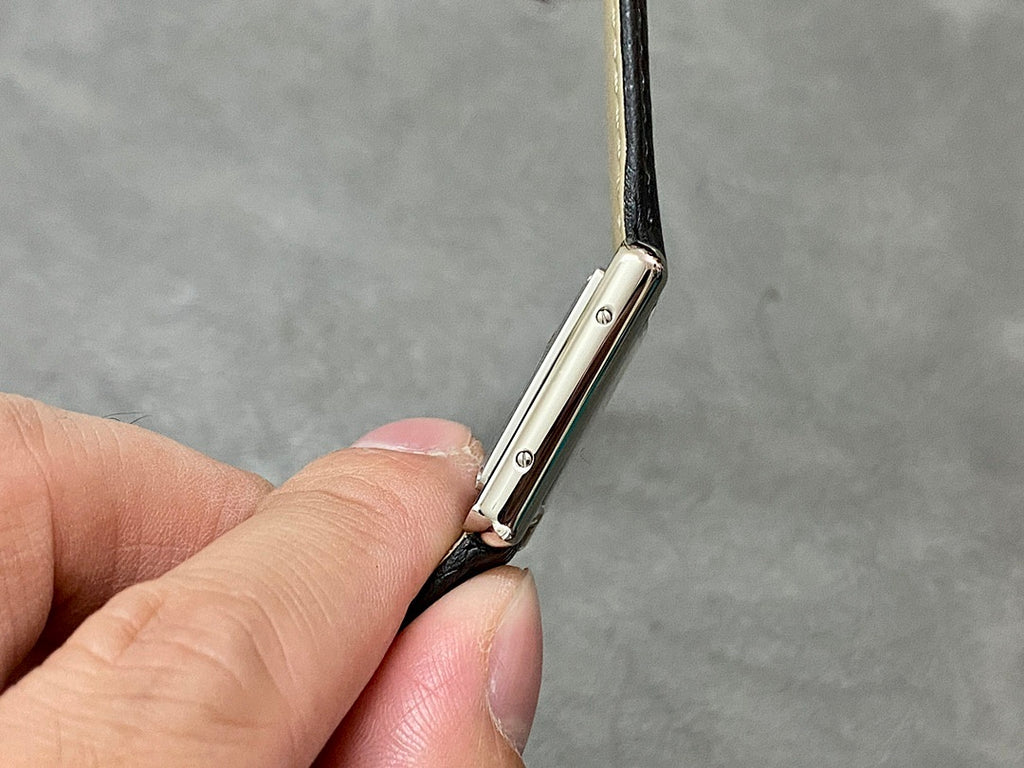 Cartier watch side profile with strap attachment and polished metal case