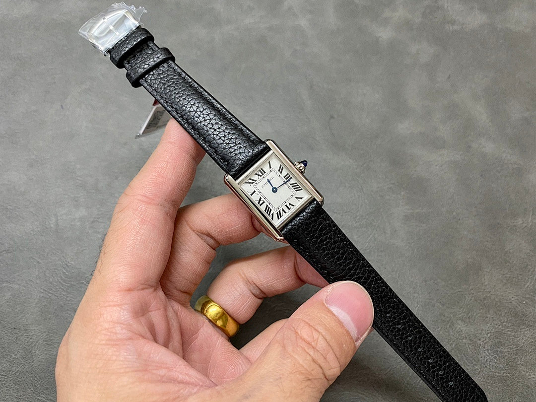 Cartier watch on black leather strap, rectangular buckle, small gold-tone accent