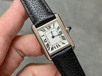 Cartier watch on black leather strap, Roman numeral dial, blue crown detail