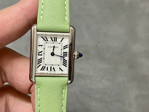 Cartier watch with green leather strap, silver case, and Roman numeral dial