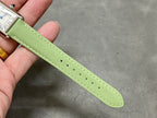 Green leather watch strap with stitched edge and perforation holes