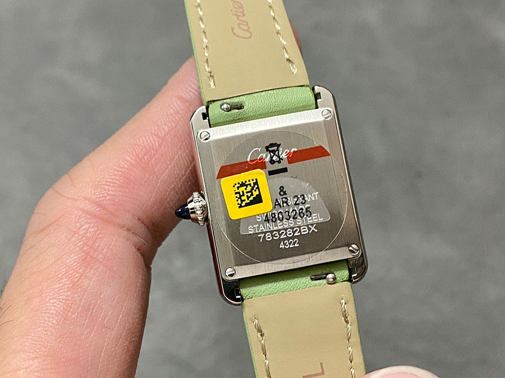 Cartier watch case back with label and green leather strap