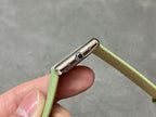 Cartier watch lugs with blue gem detail and green leather strap