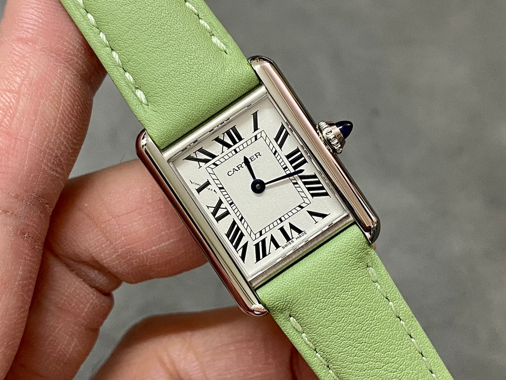 Cartier watch with green leather strap and rectangular silver dial with Roman numerals