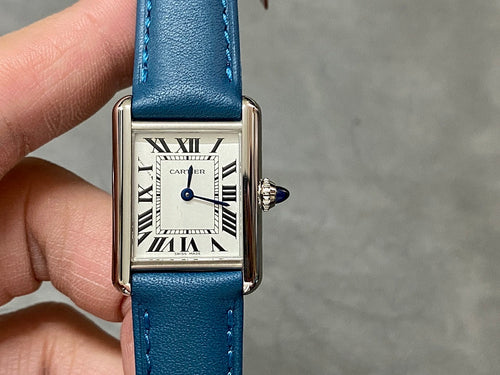 Silver square wristwatch with Roman numeral dial and blue leather strap.
