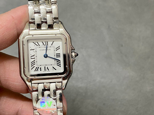 Cartier watch front with white dial, Roman numerals, and crown detail at right
