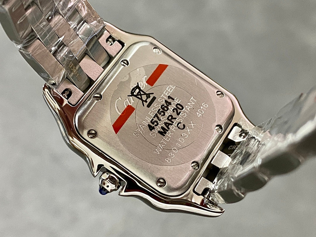 Cartier watch caseback with engraved markings and small red accent