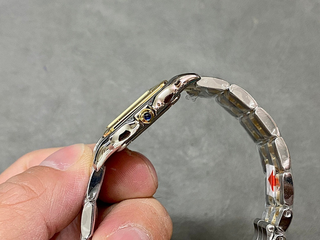 Cartier curved side view of two-tone metal case with crown and bezel details