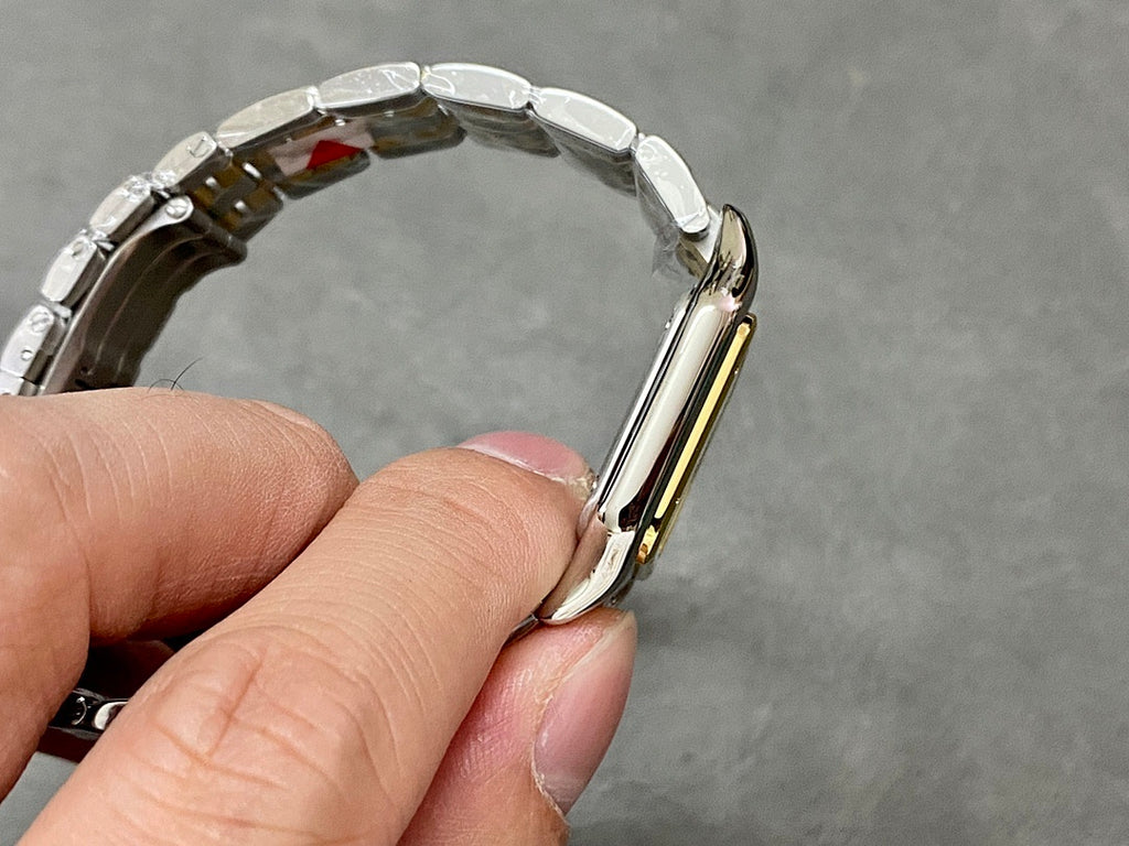 Cartier two-tone metal watch bracelet shown from the side