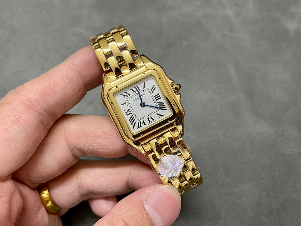 Gold Cartier watch with square face, Roman numerals, and gold link bracelet.