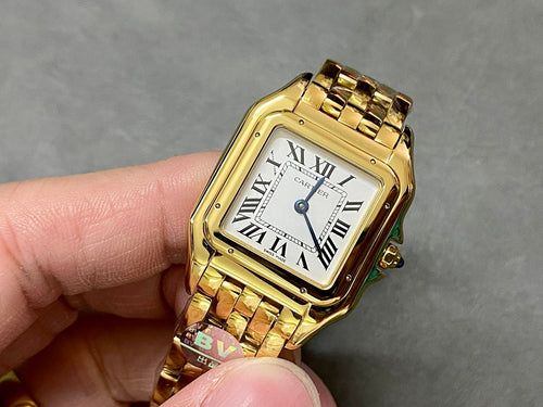 Gold Cartier watch with square face, Roman numeral dial, and gold link bracelet.