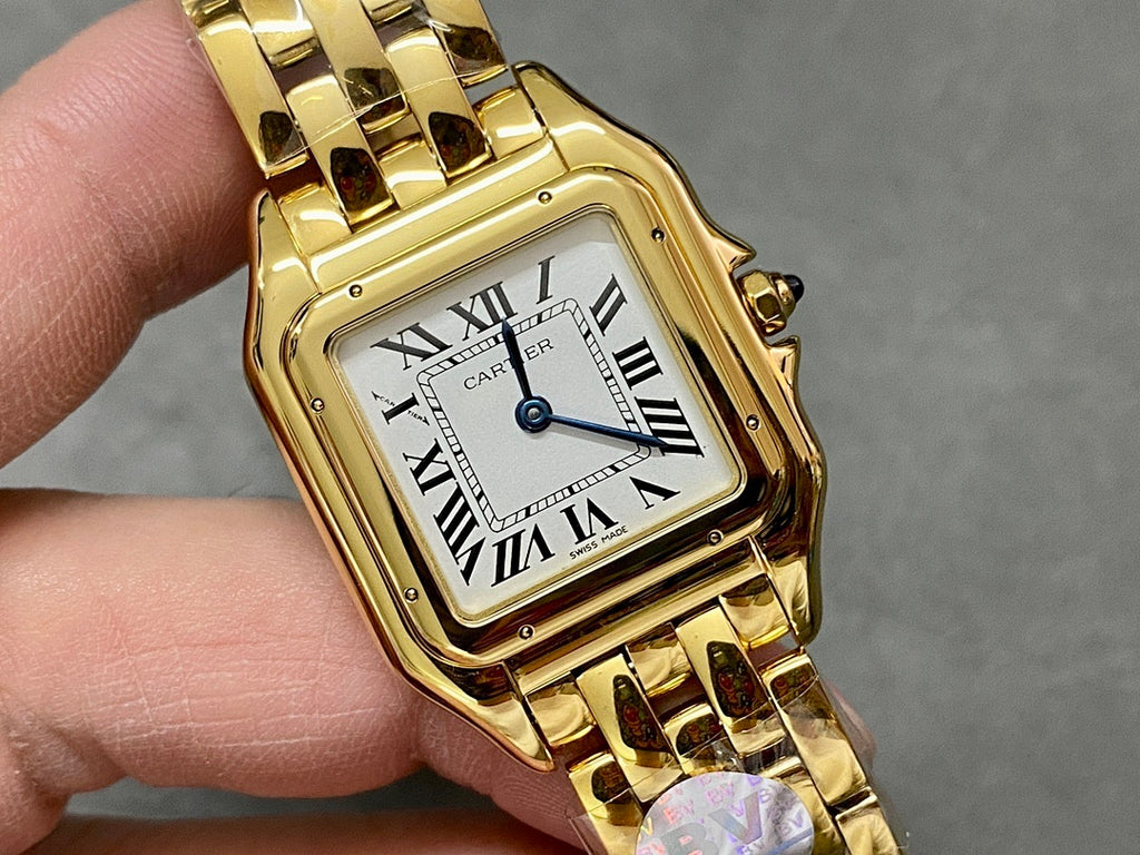 Gold Cartier watch close-up showing square dial with Roman numerals and gold case.