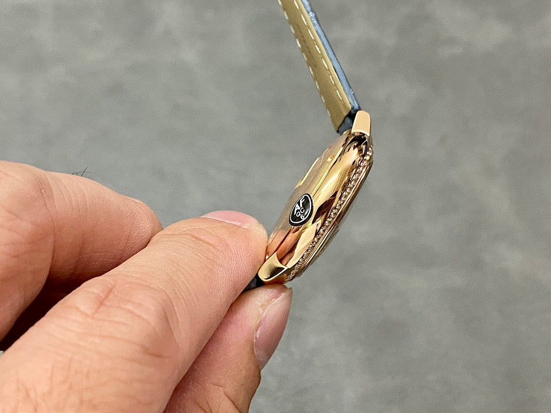 Cartier watch crown side in gold tone on blue leather strap