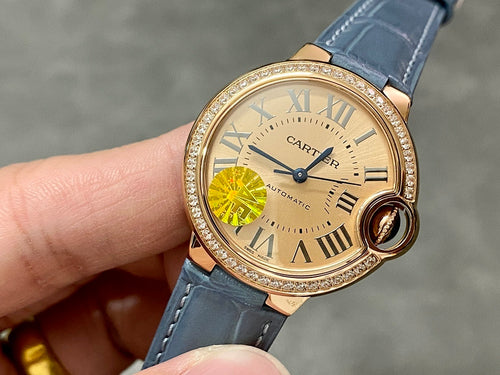 Cartier watch with gold-toned case, diamond bezel, and blue leather strap