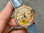 Close-up of Cartier watch dial with Roman numerals, gold case, and blue leather strap