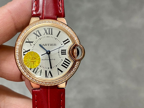 Round wristwatch on red leather strap with gold-tone bezel, Roman numeral dial and yellow subdial