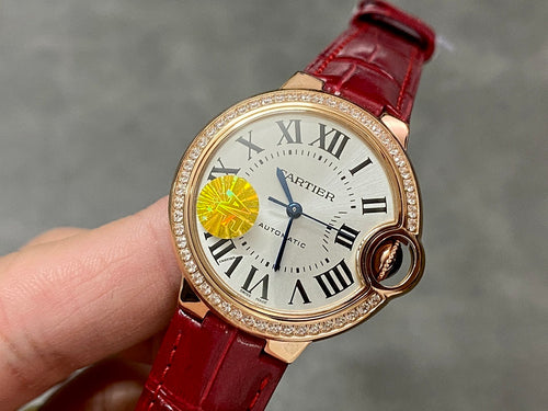 Round wristwatch with red leather strap and gold-tone case, jeweled bezel, Roman numerals dial