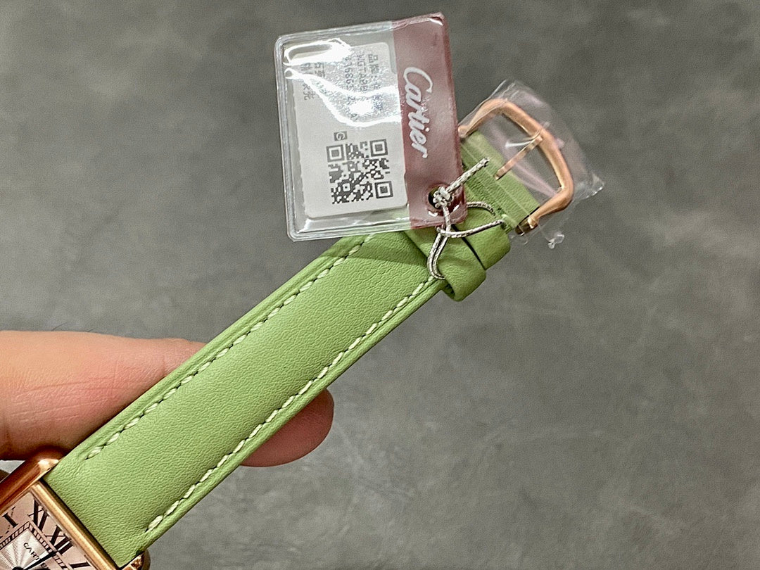 Green leather watch strap with hanging tag and gold-tone pin buckle