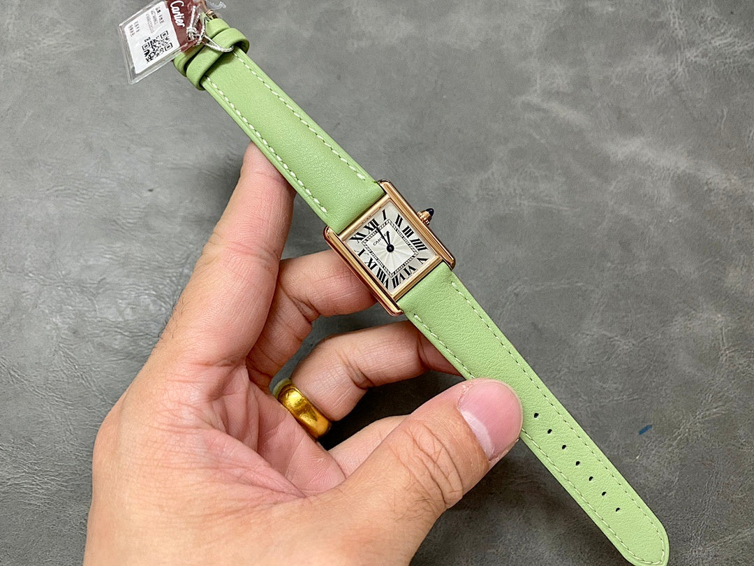 Cartier tank watch on green strap, gold-tone case, Roman numeral white dial