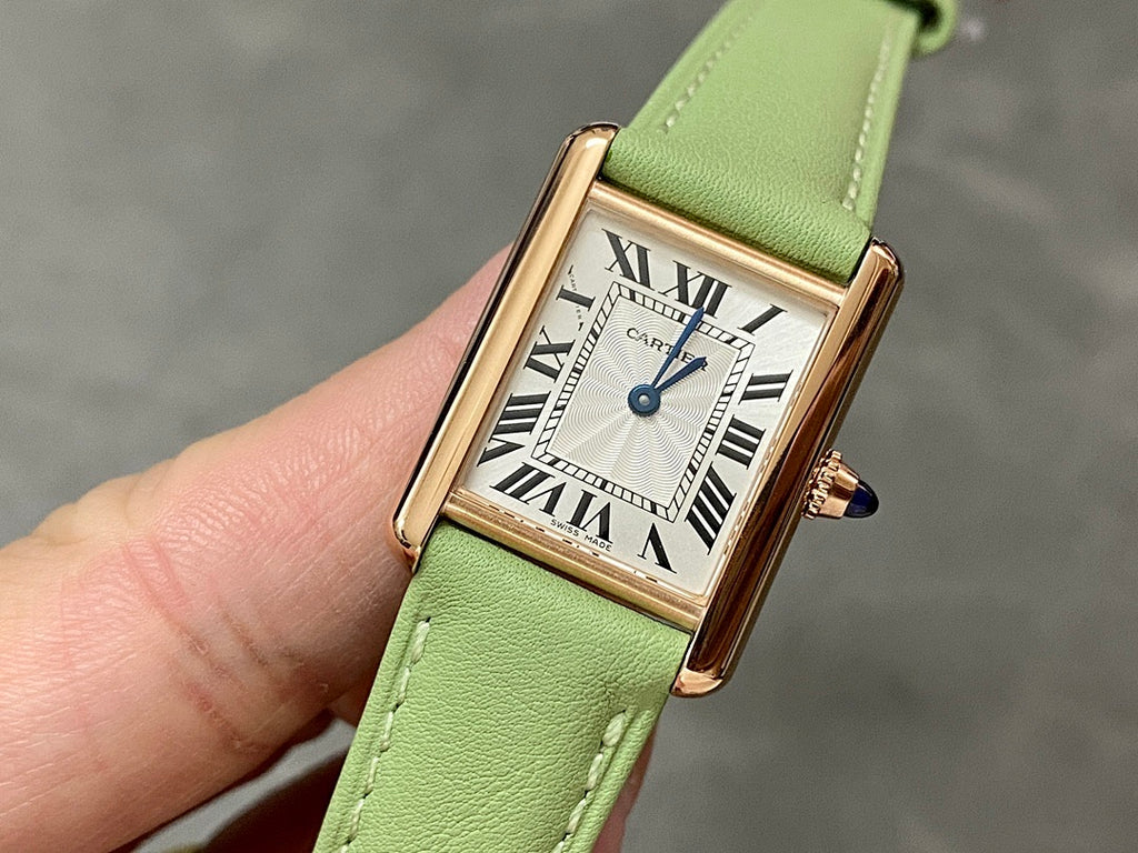 Cartier tank watch with green leather strap, gold case, Roman numeral white dial