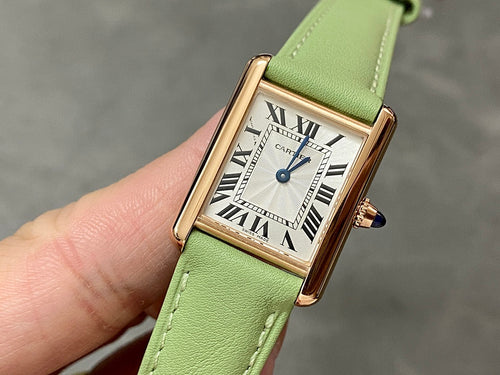 Cartier tank watch with green leather strap, gold case, Roman numeral white dial
