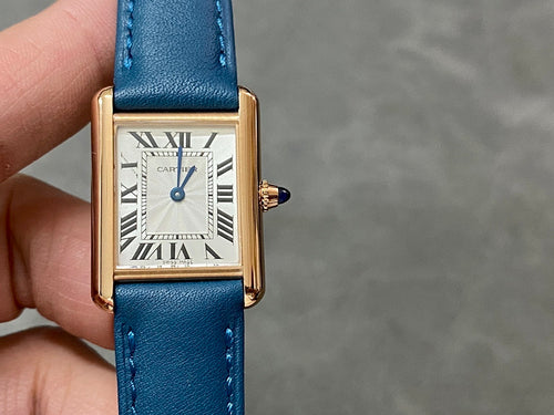 Cartier gold-tone rectangular watch with blue leather strap and white roman numeral dial