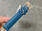 Blue leather watch strap with gold-tone buckle and rectangular clasp