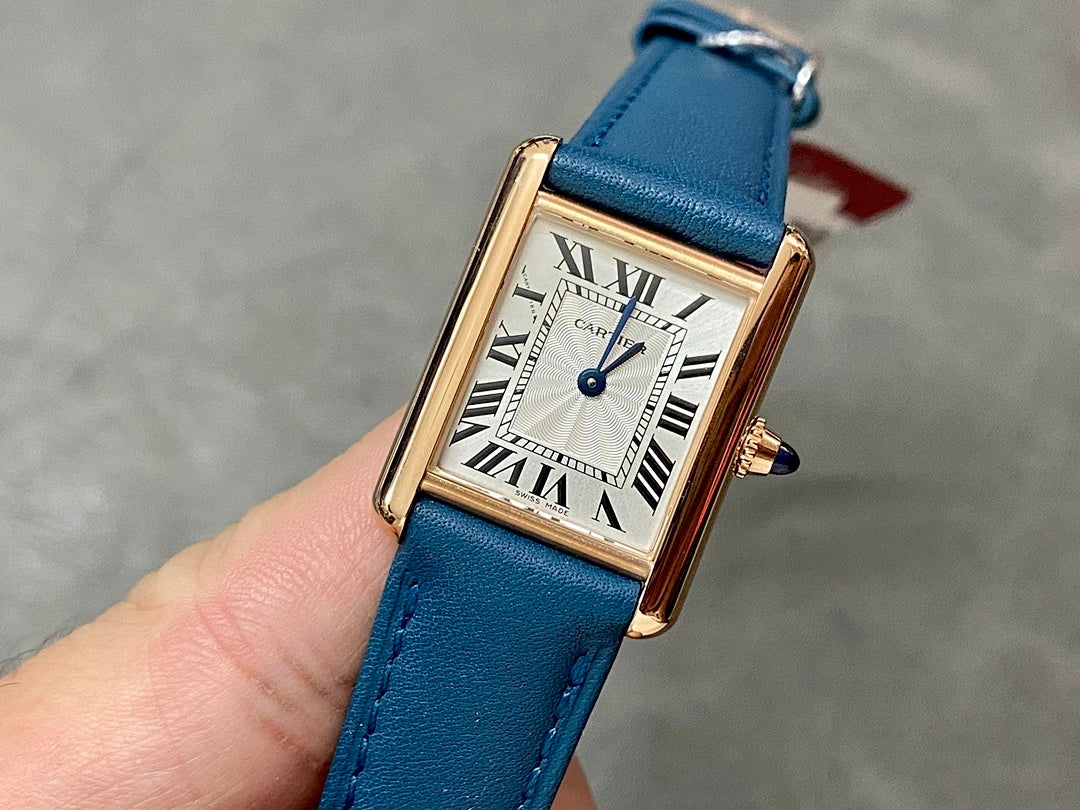 Cartier gold-tone rectangular watch, blue leather strap, white roman numeral dial