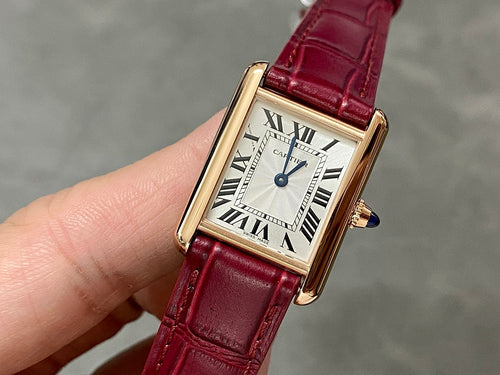 Cartier tank watch with burgundy leather strap and gold-tone rectangular case
