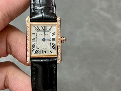 Cartier square wristwatch with black leather strap and rose-gold case, Roman numeral dial.