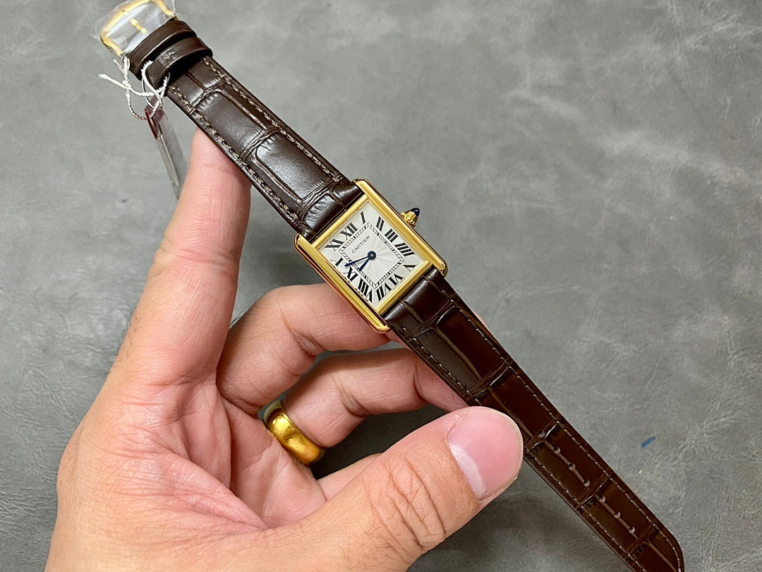 Cartier watch on brown leather strap with gold buckle, white dial and Roman numerals