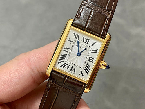 Rectangular wristwatch with gold-tone case, Roman numeral dial, and brown leather strap