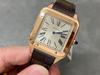 Cartier Santos watch with rose-gold case, black leather strap, Roman numeral dial.