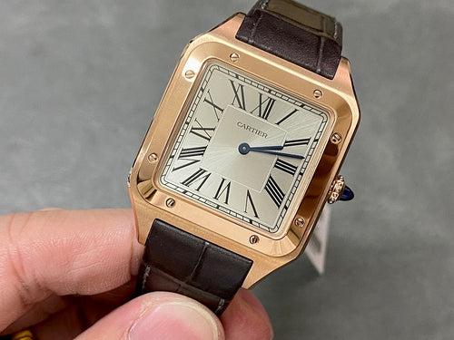 Cartier Santos watch with rose-gold case, black leather strap, Roman numeral dial.