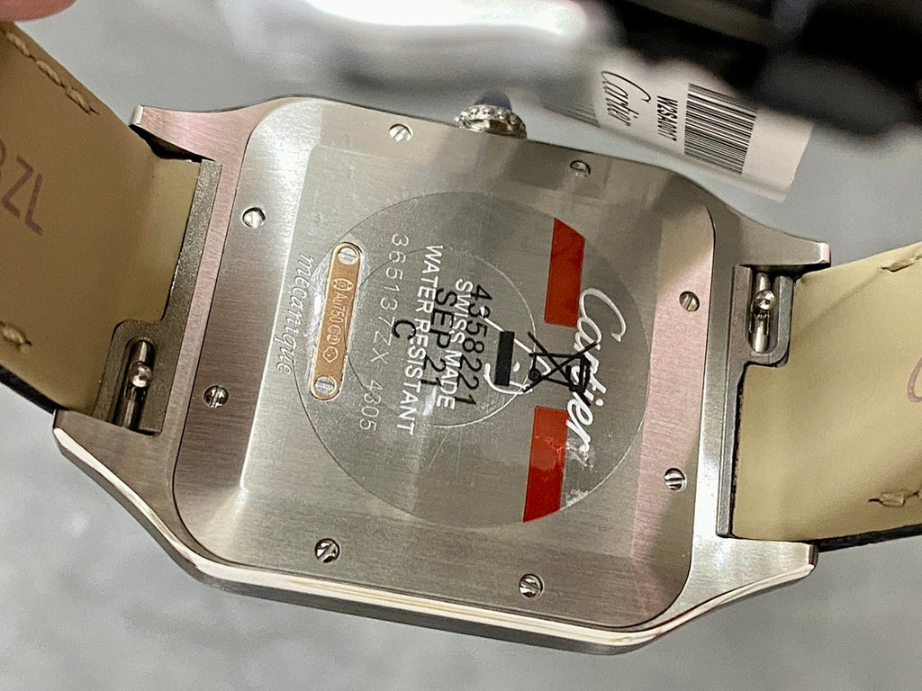 Cartier watch case back with engraved markings and leather strap edges