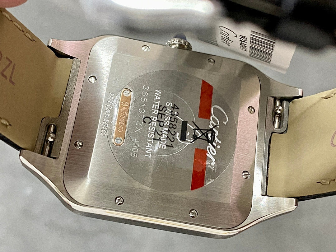Cartier watch case back with engraved markings and leather strap edges