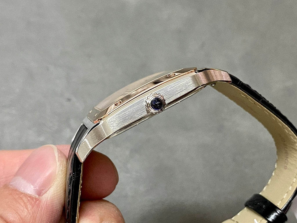Cartier watch side view with rose gold-tone case and black leather strap