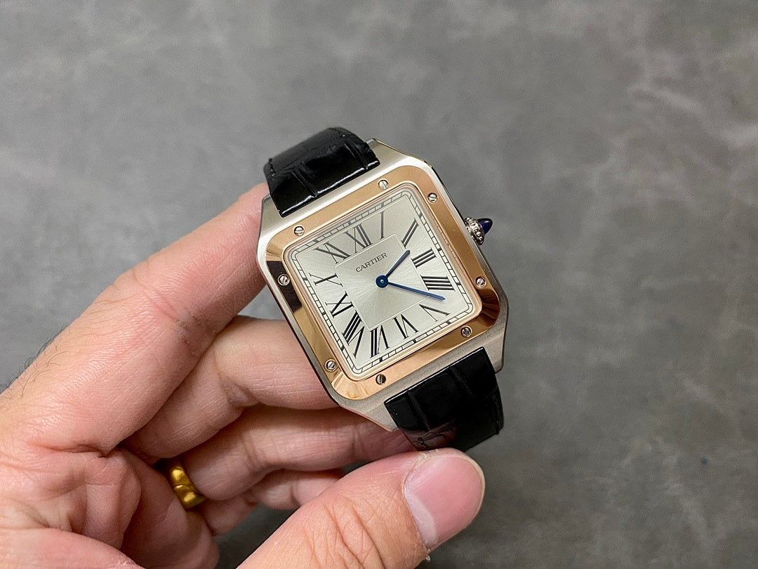 Cartier watch held in hand with rose gold-tone square case and black leather strap
