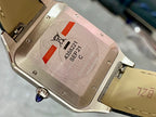 Cartier watch case back with screw details, Swiss Made text, and serial markings.