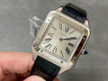 Cartier rectangular watch with black leather strap, Roman numeral dial, silver case.
