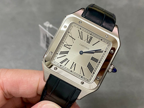 Cartier rectangular watch with black leather strap, Roman numeral dial, silver case.