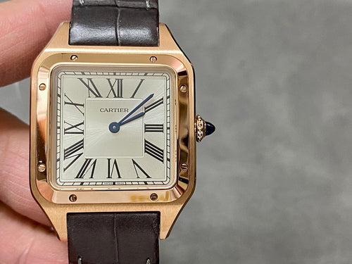 Cartier watch in gold-tone with white dial, Roman numerals, blue hands, black leather strap