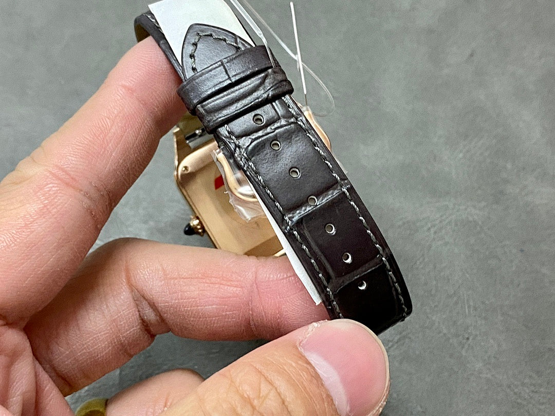 Cartier watch with gold-tone case and black leather strap, underside view with strap holes