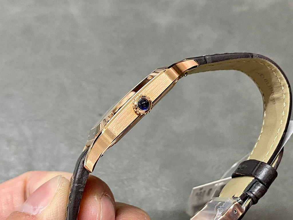 Cartier watch with gold-tone case and black leather strap, side profile with blue accent