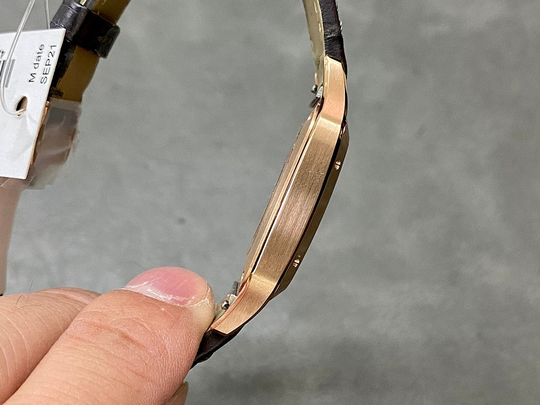 Cartier watch side view showing gold-tone case edge and black leather strap link