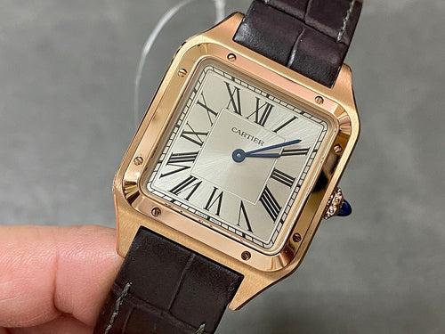 Cartier watch with gold-tone square case, white dial, Roman numerals, black leather strap
